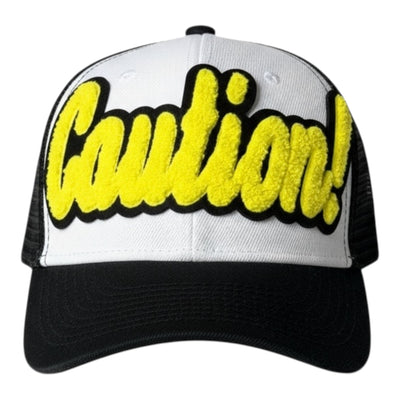 White and black cap with yellow 'Caution!' text on a white background