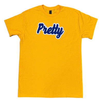 Gold t-shirt with the word 'Pretty' sewn on it against a white background