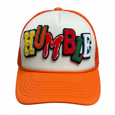 Orange and white cap with colorful 'HUMBLE' text on a white background