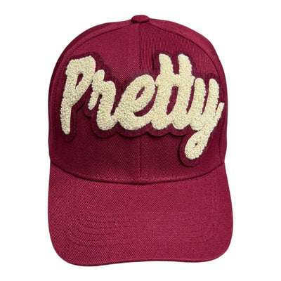Maroon cap with 'Pretty' in beige on a white background