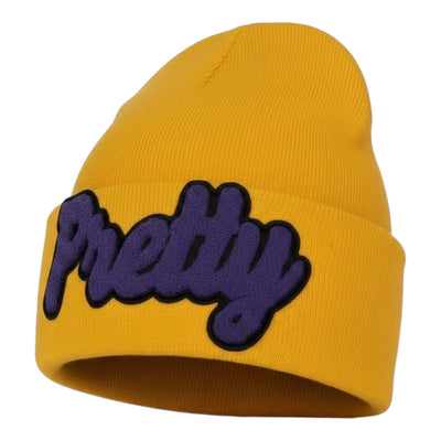 Yellow beanie with purple 'Pretty' text on a white background