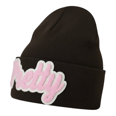 Black beanie with pink and cream 'Pretty' patch on a white background
